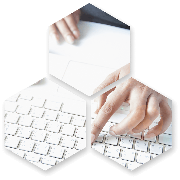 Manos escribiendo en teclado blanco de portátil